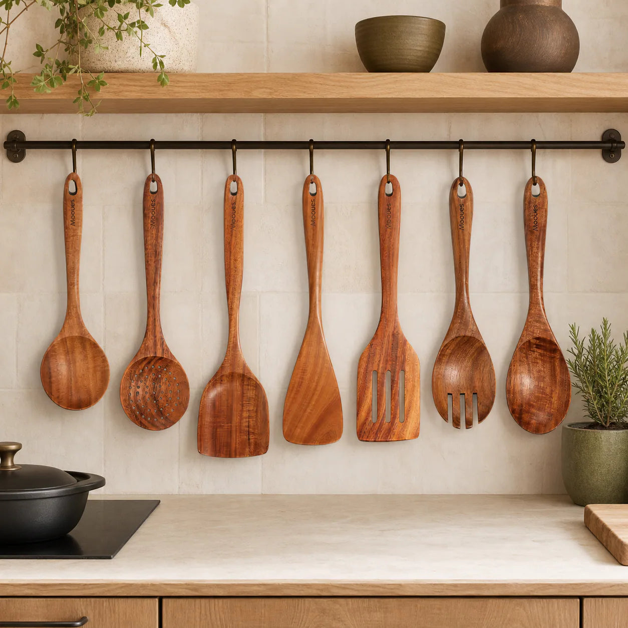 Seven Mooues teak cooking utensils in a warm natural kitchen